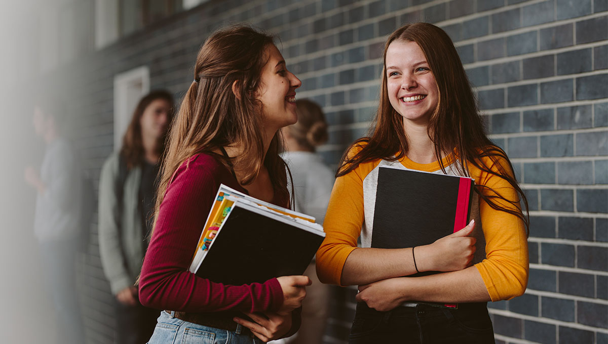 Two students smiling together