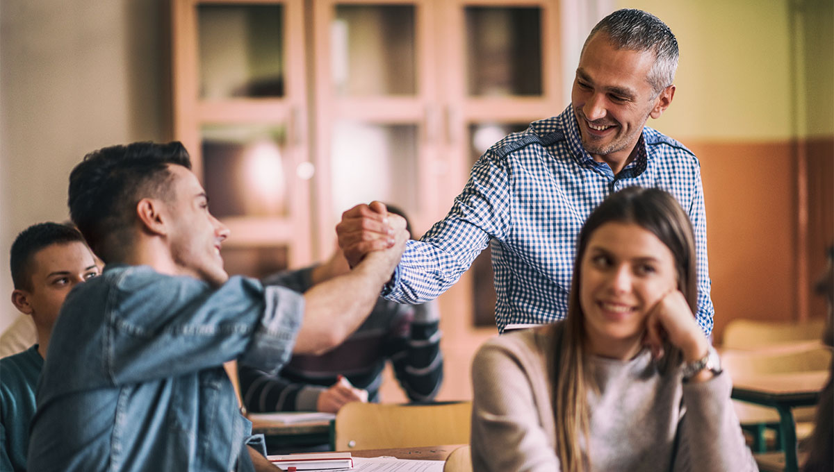 Teacher and student doing a handshake